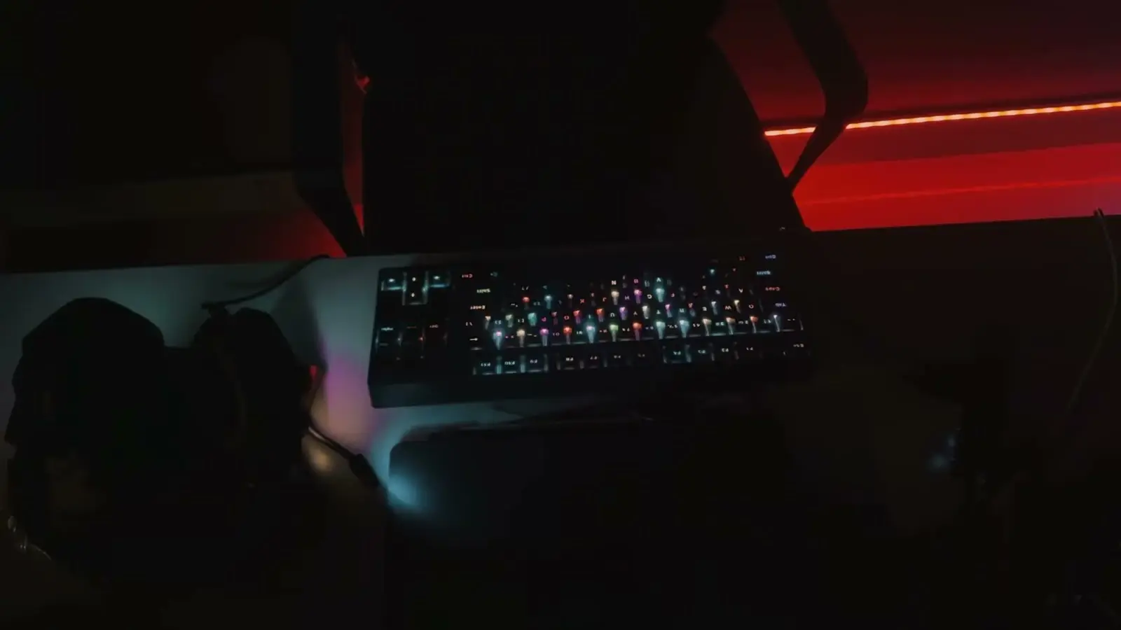 A keyboard under red light in the studio at night, from the late-grind reel.