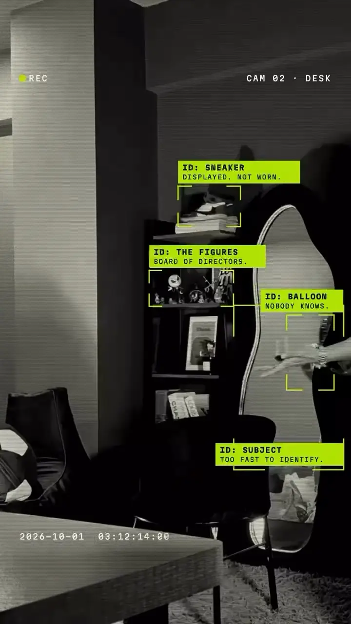 A frame from Drifted's office-camera reel: the desk, with lime tags on everything in shot.